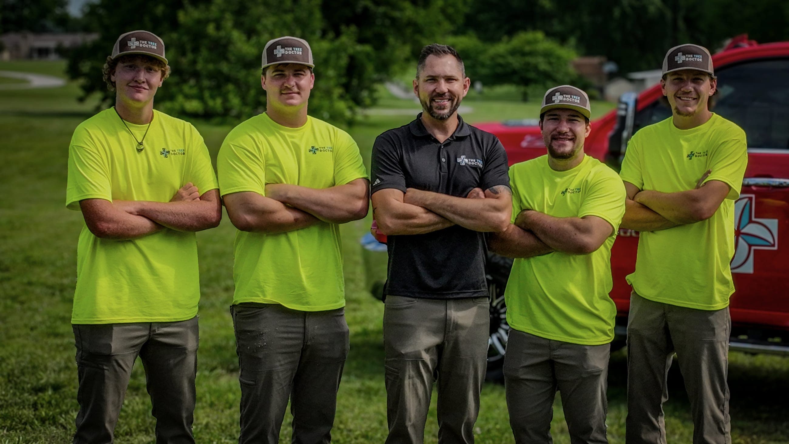 The Tree Doctor crew standing together in front of a company truck in Springfield, Missouri